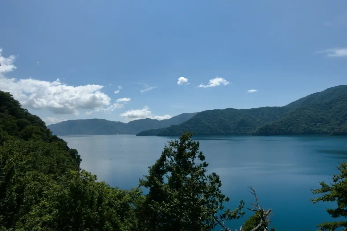 Blue Lake Chuzenji surrounded by green mountains, seen from an elevated viewpoint