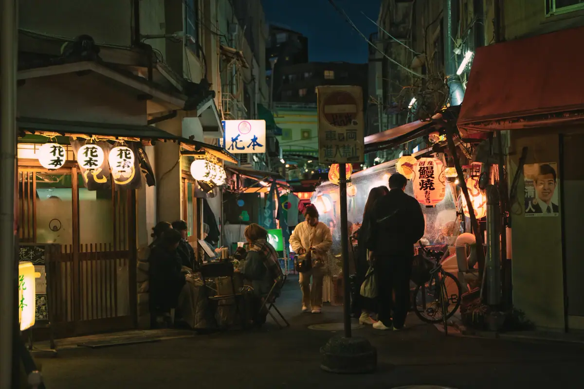 People walking along a lantern-lit street in Asakusa